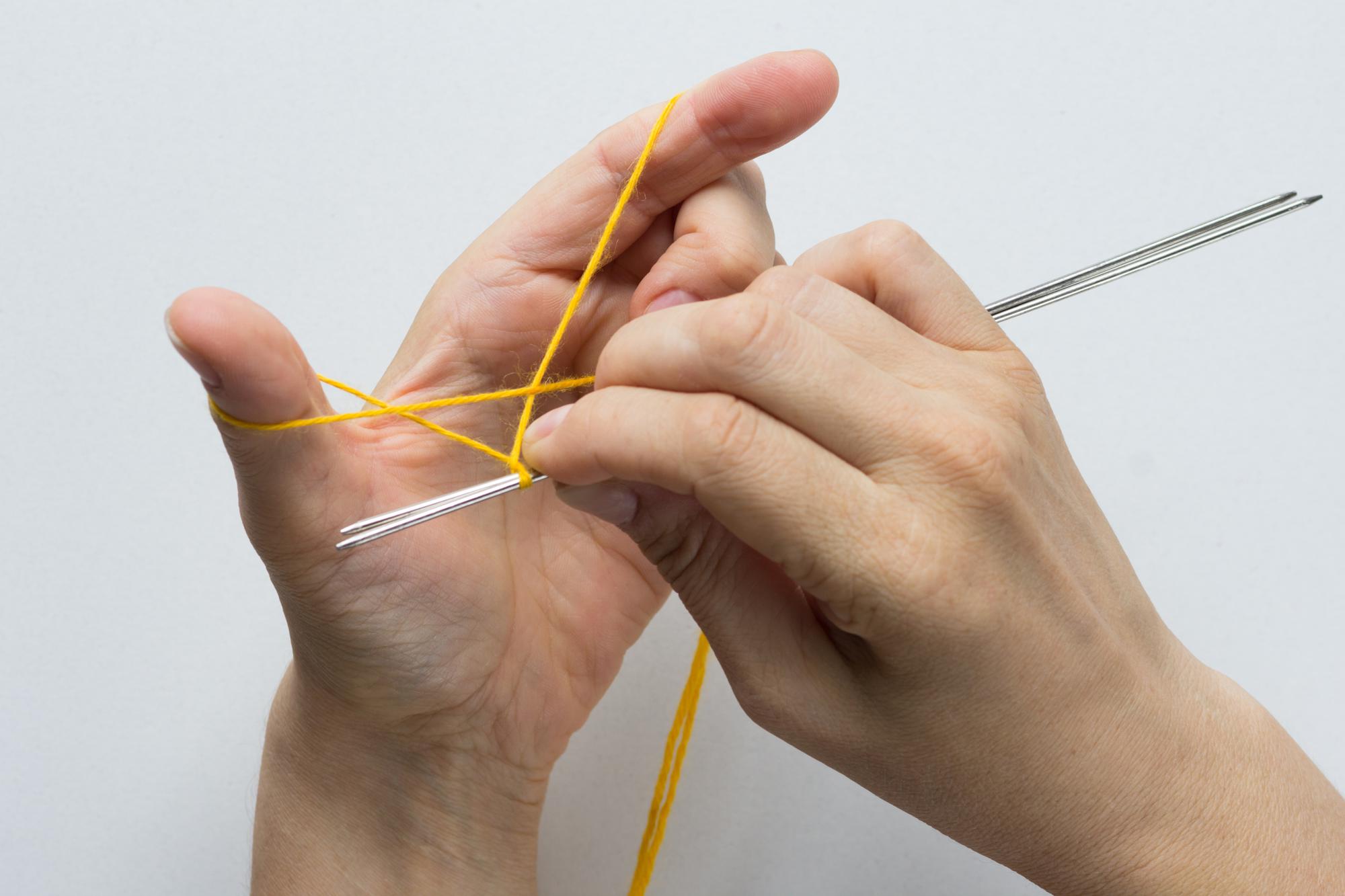 Hands preparing threads and needles